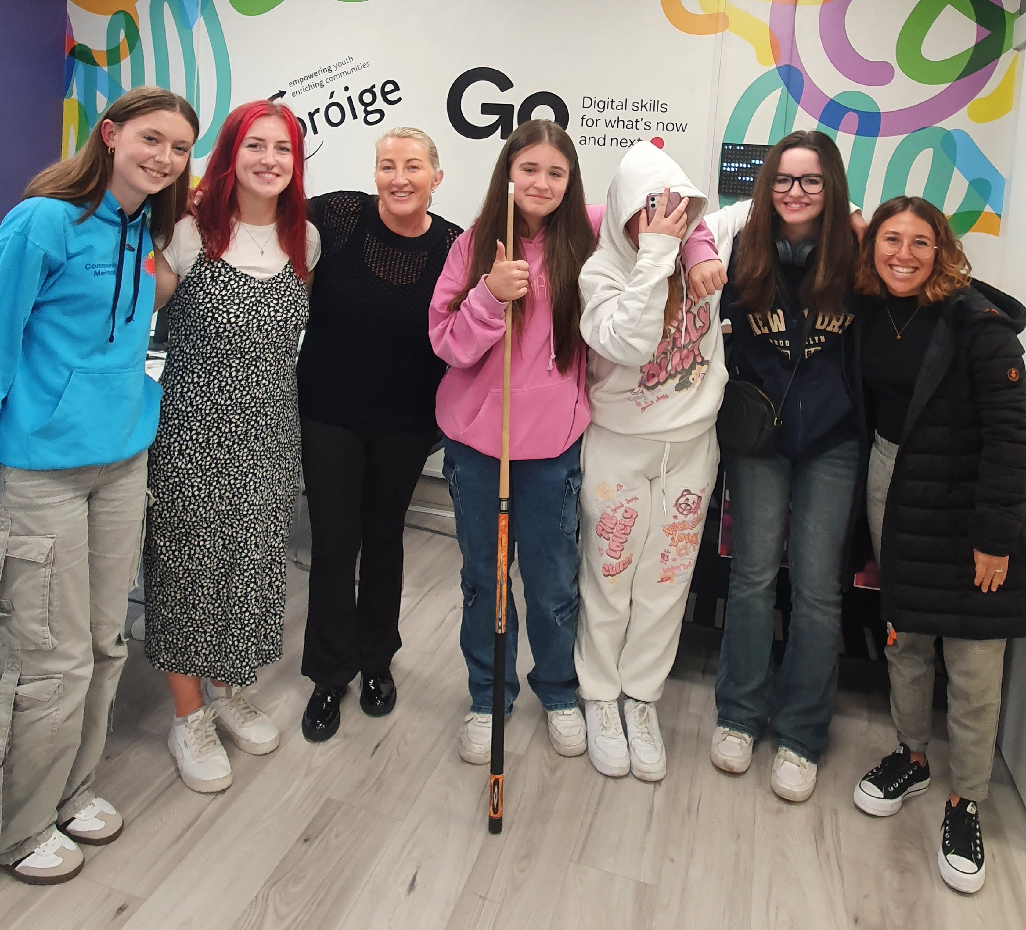 A group of students standing together in a half circle.