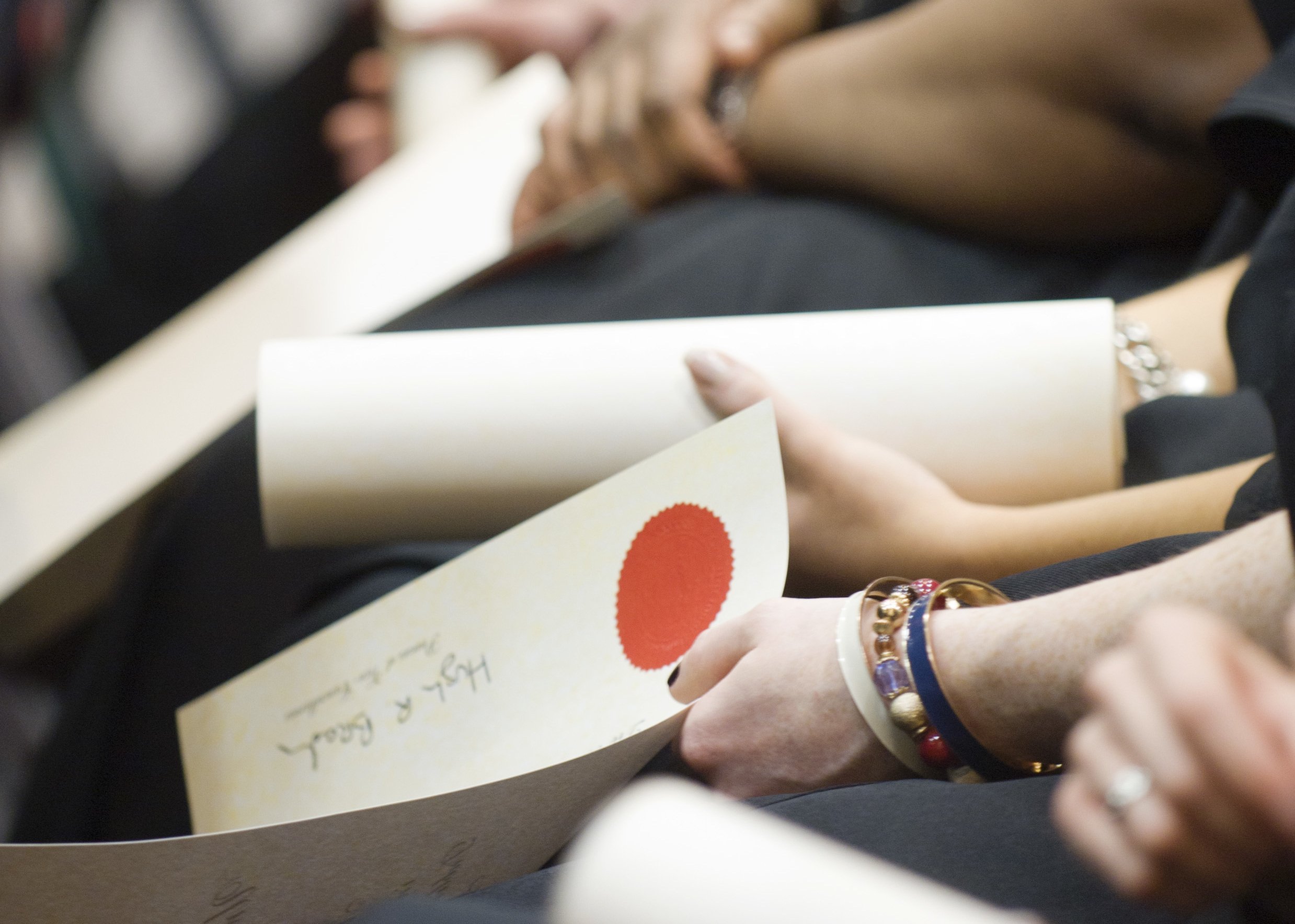 Students holding their conferring scroll.