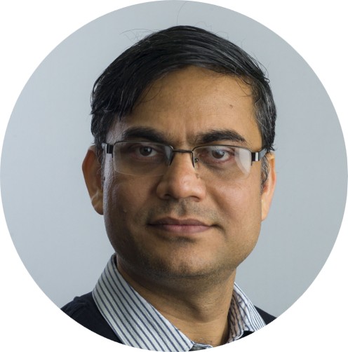 a profile photo of a man wearing glasses