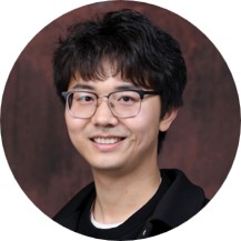 a profile photo of a man wearing glasses