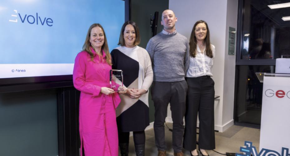 Group of three women and one man with an award