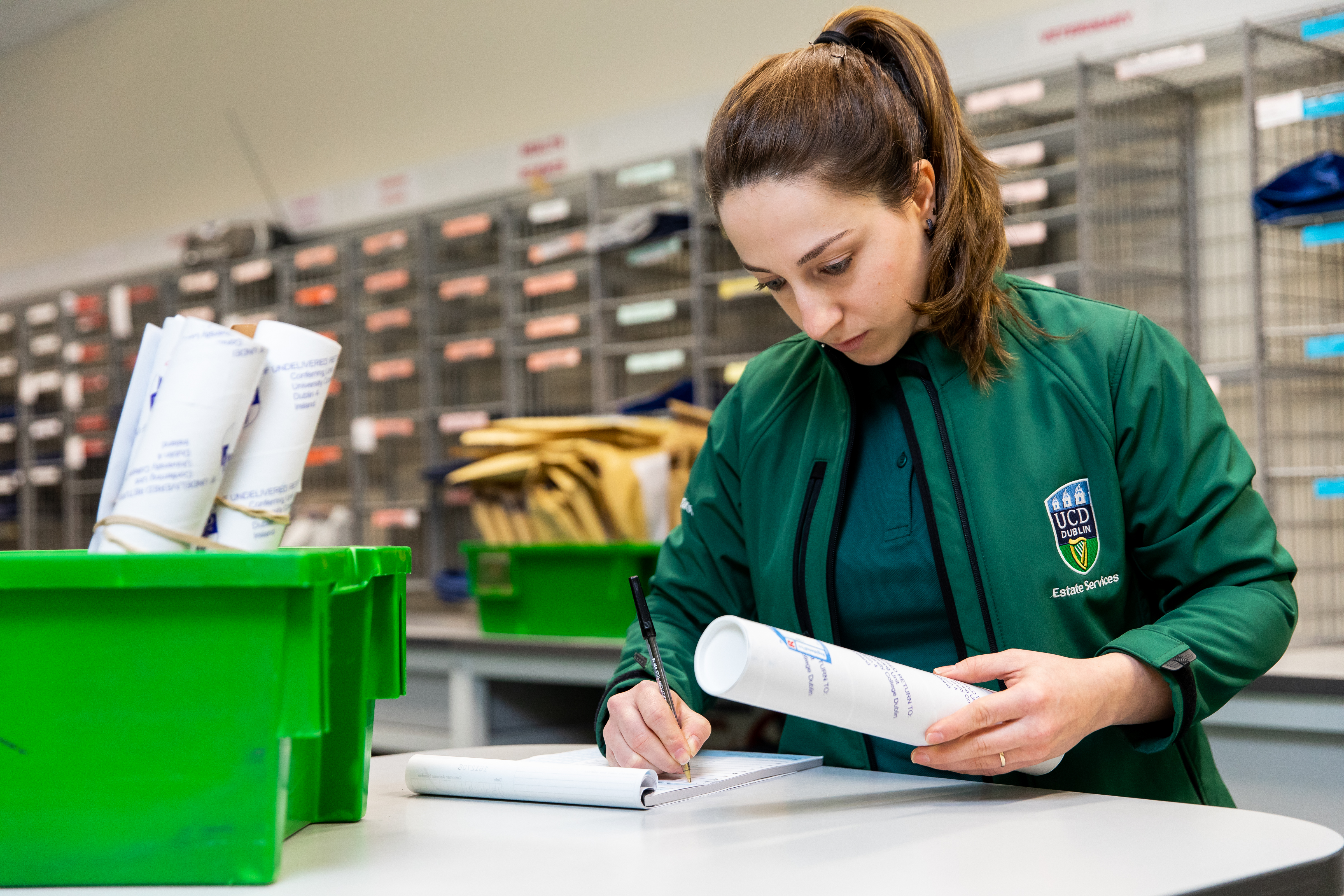 Staff member checking off list of parcels