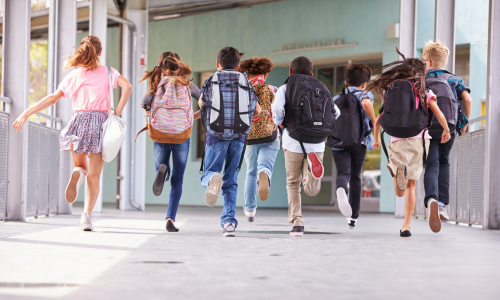 children running away with backpacks
