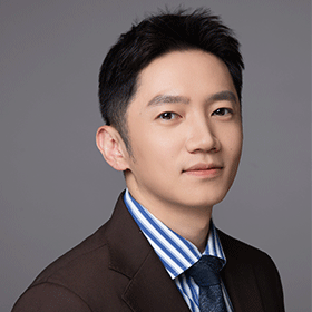 A man with dark brown hair, a pinstriped shirt and suit jacket.