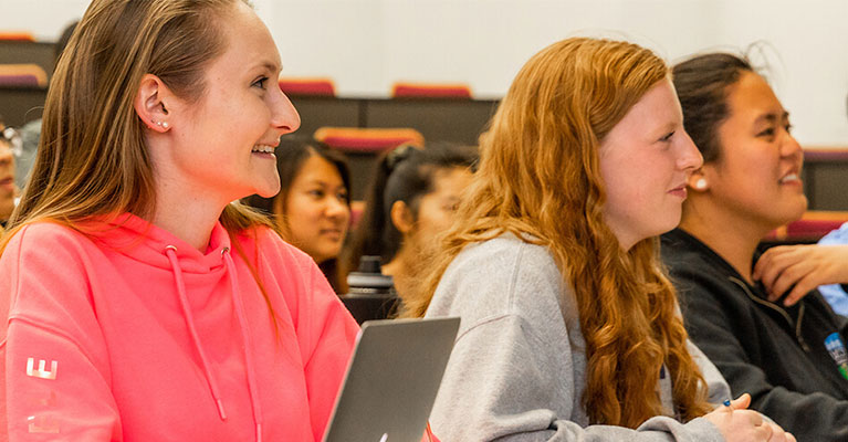 A group of students listen intently during a lecture.