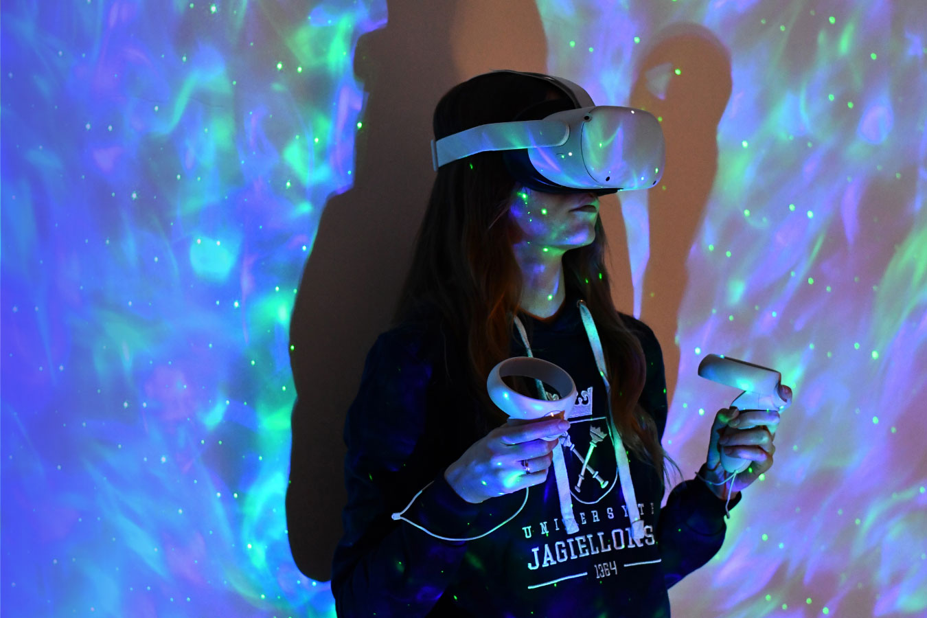 A student wearing an AI headset in front of an illuminated backdrop.