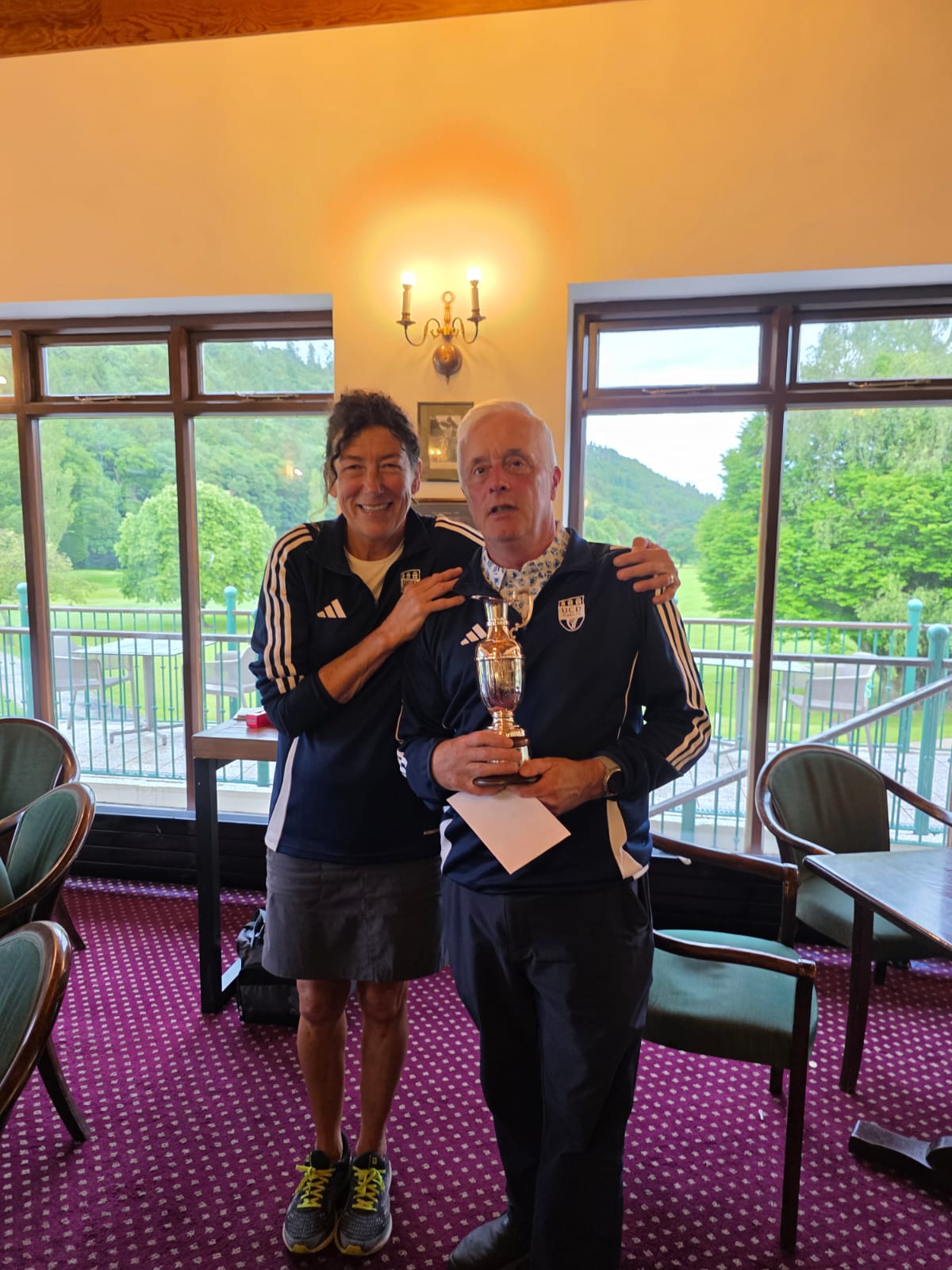 Stewart McKee accepting winning prize from Captain Vicki McDonnell