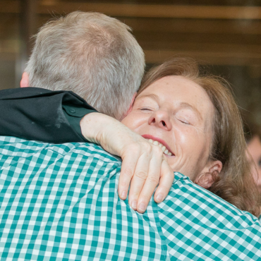 Two people hugging at the UCD Physiotherapy 70th anniversary celebration