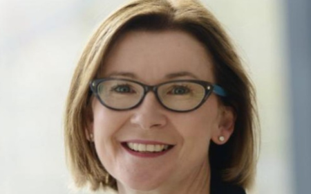 Woman wearing glasses smiling to camera