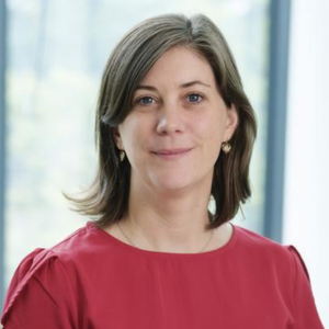 Woman in a red top smiling to camera