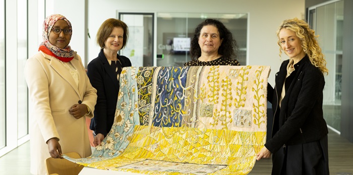 A photo of Dr Sara Dakir, PhD student and SpR Pathology, UCD School of Medicine & UCD Conway Institute; Elaine Quinn, Institute Manager (Communications & Education), UCD Conway; Lorna Donlon, artist and Dr Ruth Freeman, Director, Science for Society, Science Foundation Ireland.