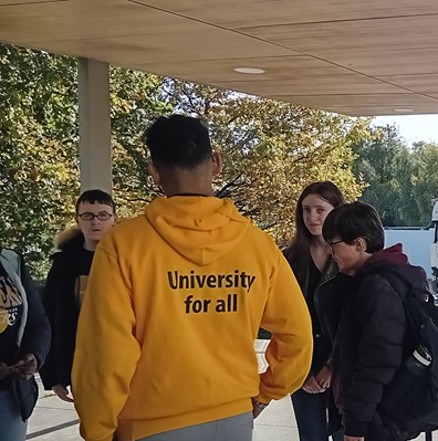 Student in branded hoodie giving tour